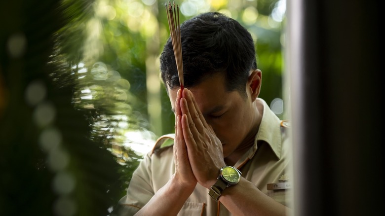 Gaitok praying on the white lotus