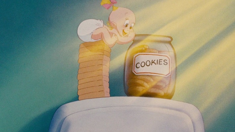 Baby precariously reaches for cookies 