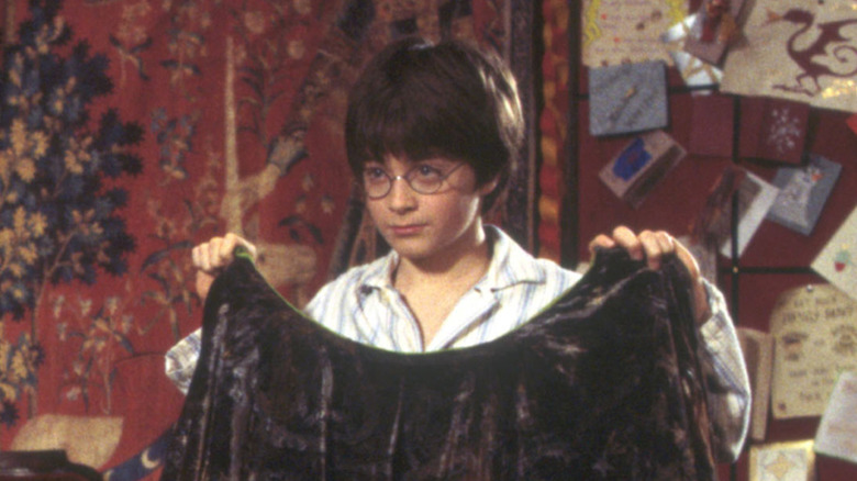 Harry holding up the cloak in Harry Potter and the Sorcerer's Stone