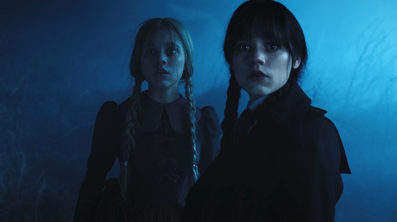 Goody and Wednesday seem spooked by something offscreen in Wednesday