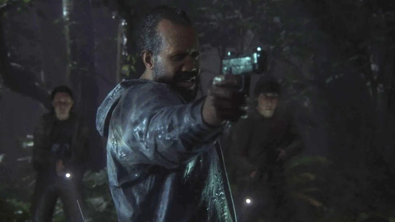 Jeffrey Wright's Isaac pointing a gun in The Last of Us Part II