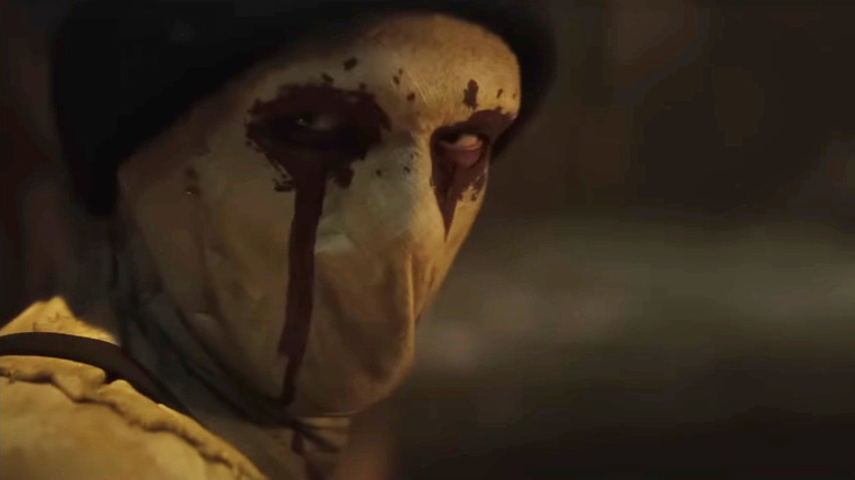 Muse turning around to reveal his mask in Daredevil: Born Again