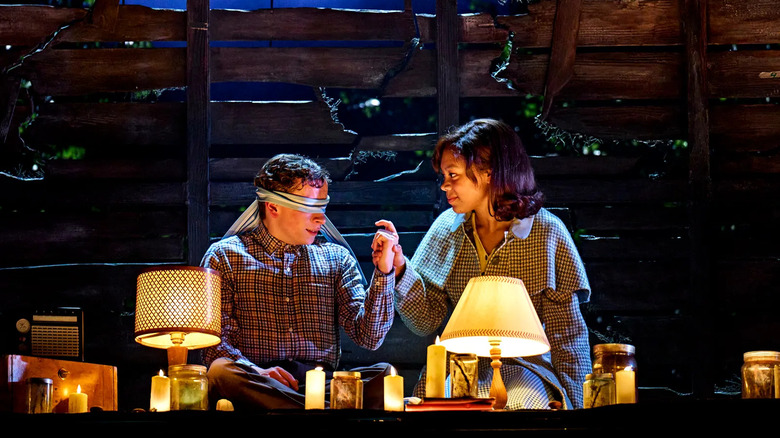 Patty holding Henry's hand in Stranger Things: The First Shadow