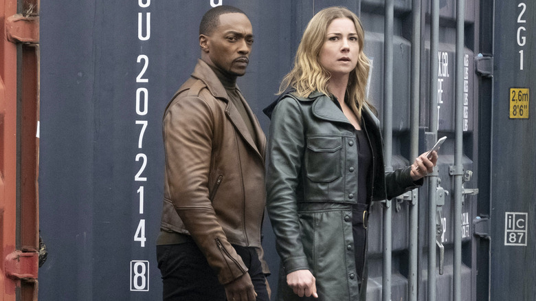 Sam Wilson and Sharon Carter walking by shipping containers in The Falcon and the Winter Solder