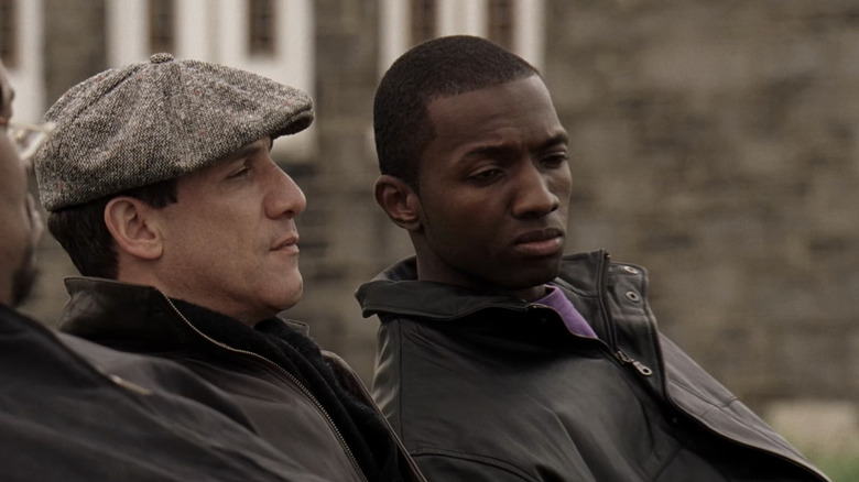 Paul Ben-Victor's Spiros "Vondas" Vondopoulos sits beside Jamie Hector's Marlo Stanfield in The Wire