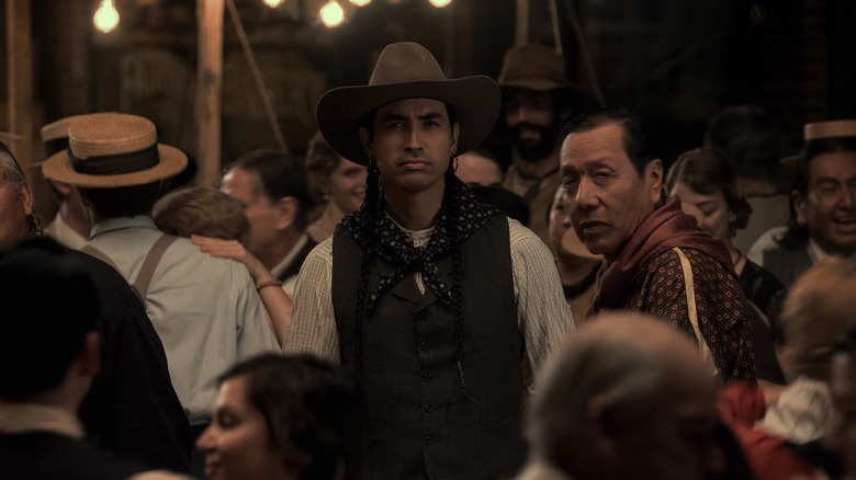 Tatanka Means' John Wren standing in a crowd in Killers of the Flower Moon