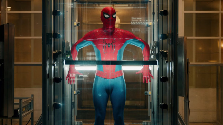Tom Holland as Peter Parker wearing his superhero suit while getting scanned in a containment room in Spider-Man: Brand New Day