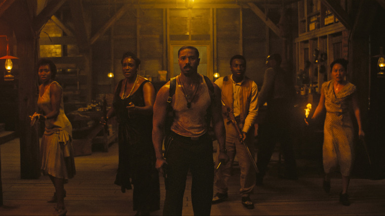Jayme Lawson as Pearline, Wunmi Mosaku as Annie, Michael B. Jordan as Smoke, Miles Caton as Sammie, Delroy Lindo as  Delta Slim, and Li Jun Li as Grace standing in a warehouse with weapons in Sinners