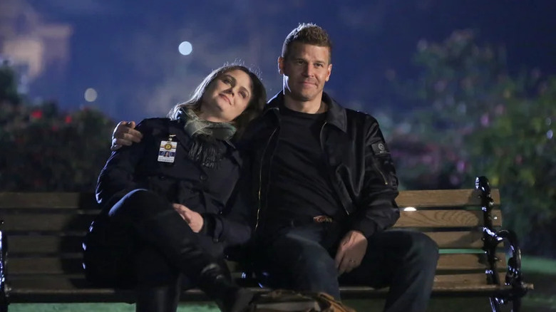 Emily Deschanel's Temperance Brennan lays her head on David Boreanaz's shoulder as they sit on a bench in Bones