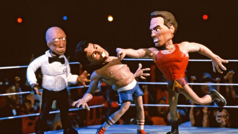 Arnold Schwarzenegger punching Sylvester Stallone while Mills Lane looks on in Celebrity Deathmatch