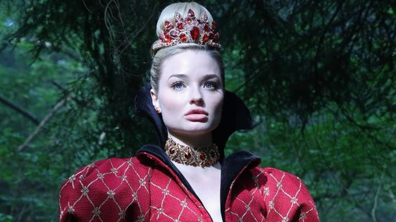 Emma Rigby as the Red Queen standing in the forest in Once Upon a Time in Wonderland