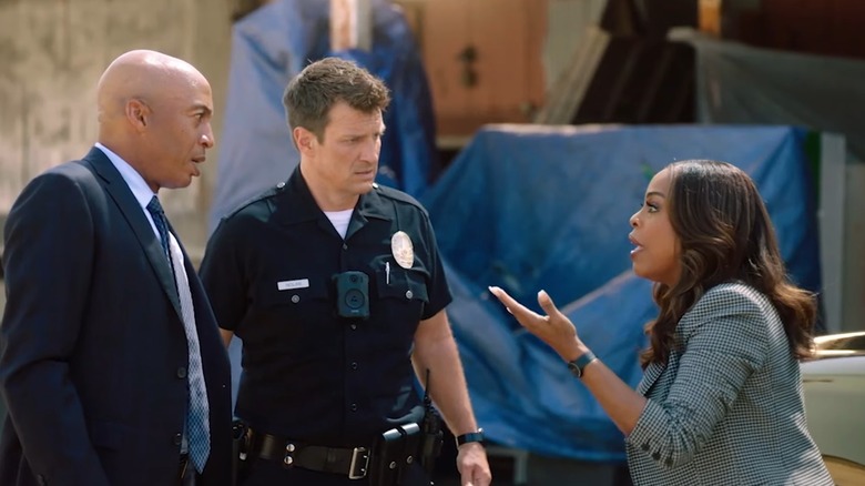 James Lesure's Carter Hope and Nathan Fillion's John Nolan listen to Niecy Nash-Betts' Simone Clark as she explains something in The Rookie: Feds
