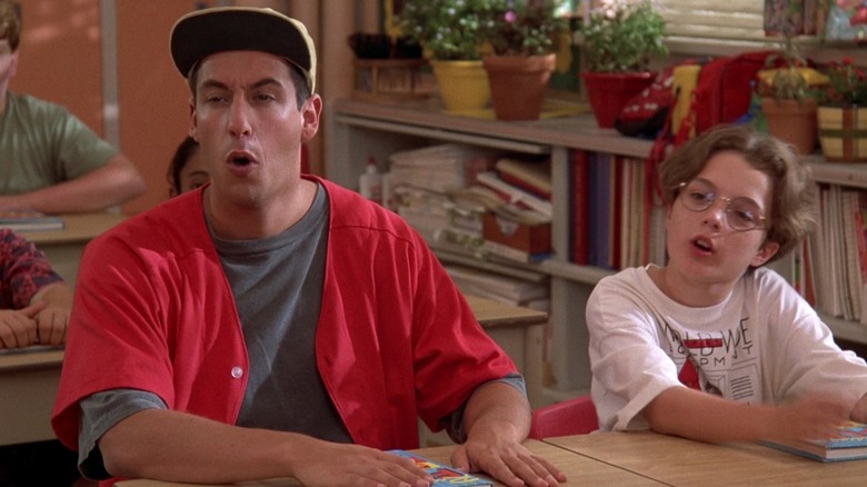 Adam Sandler sits down on desk at school in Billy Madison