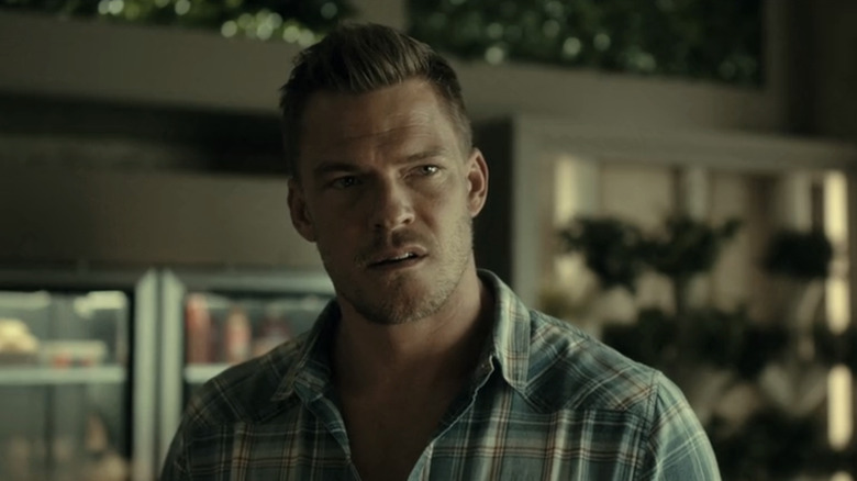 Alan RItchson as Hank Hall looks across frame in closeup in Titans