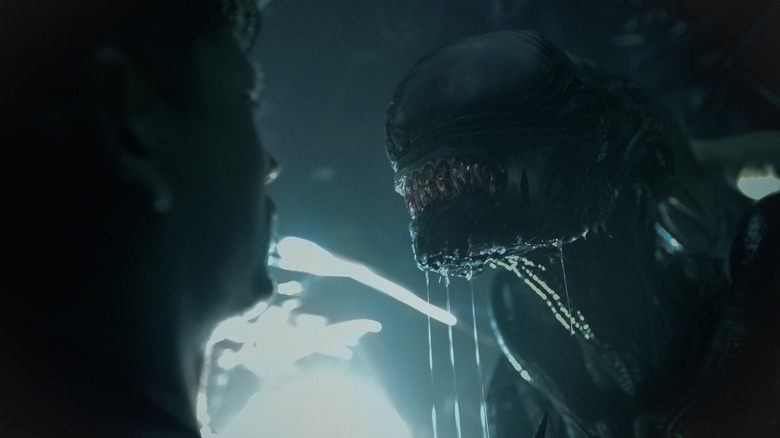 Cailee Spaeny as Rain encounters a Xenomorph in a brightly lit room in Alien: Romulus