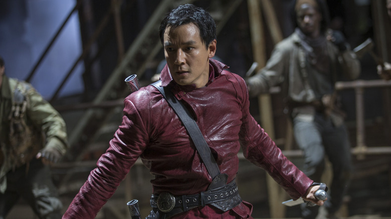 Danil Wu as Sunny surrounded by enemies with his knives out in Into the Badlands