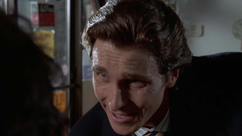 Patrick Bateman making a bizarre expression in American Psycho