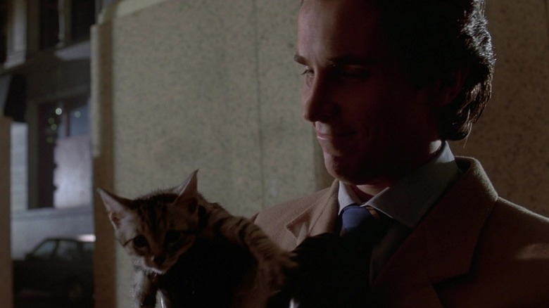 Patrick Bateman holding a kitten in American Psycho