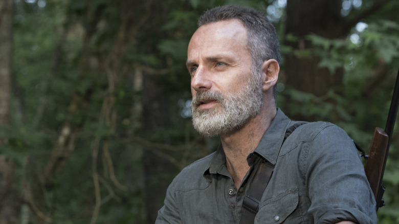 Andrew Lincoln's Rick Grimes standing on the bridge in The Walking Dead season 9