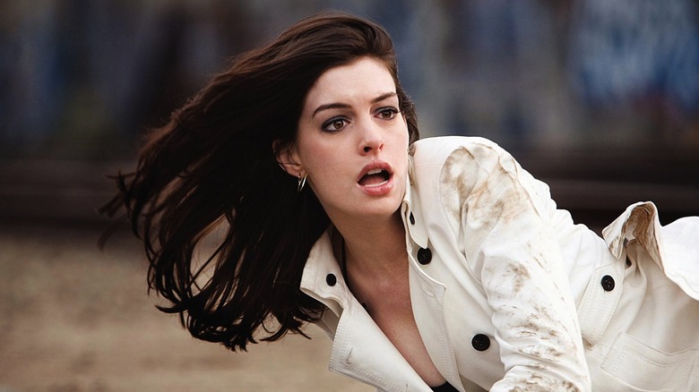 Anne Hathaway as Agent 99 laying down in her white jacket in Get Smart
