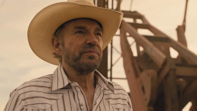 Billy Bob Thornton as Tommy Norris standing by an oil rig in Landman