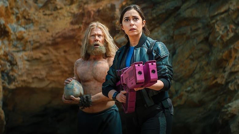 Walton (Jimmi Simpson) with long hair and beard standing behind clone Nanette (Cristin Miliotti) with pink gun on Black Mirror