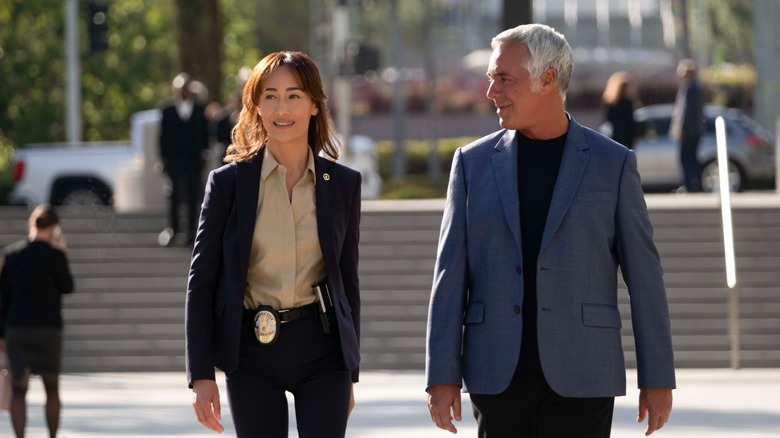 Ballard and Bosch share a moment of respite while solving a case in Ballard