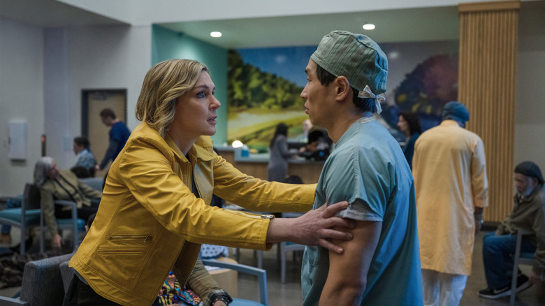 Rhea Seehorn as Carol Sturka grabbing a doctor by the shoulders in Pluribus