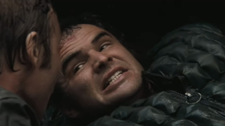 Burt Reynolds' Lewis Medlock is seen grimacing in closeup in Deliverance