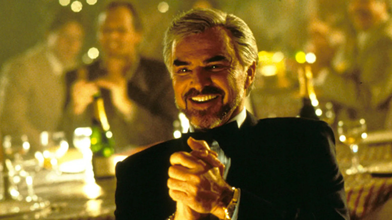 Burt Reynolds' Jack Horner wearing a tux and clapping in Boogie Nights