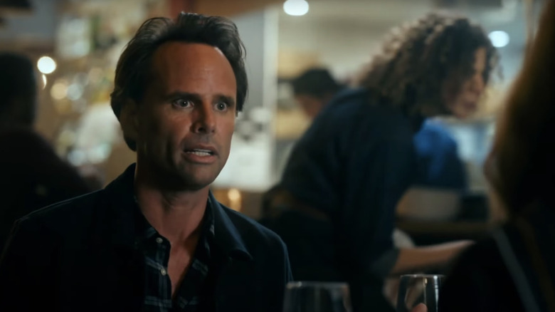 Walton Goggins' Wade Felton looks surprised as he sits at a table in The Unicorn