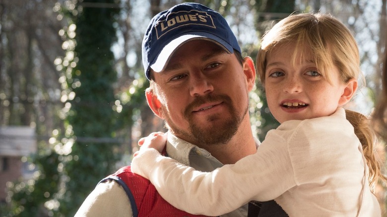 Channing Tatum as Jimmy carrying Farrah Mackenzie as Sadie in Logan Lucky