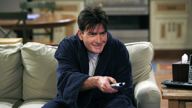 Charlie Sheen as Charlie in a bathrobe with a creepy smile on Two and a Half Men