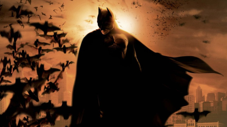 Batman Begins poster, Batman posing surrounded by swarm of bats