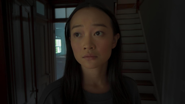 Callina Liang as Chloe standing in front of the stairs in Presence