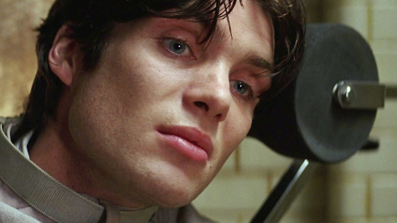 Jonathan Crane strapped to a chair in a straitjacket in Batman Begins