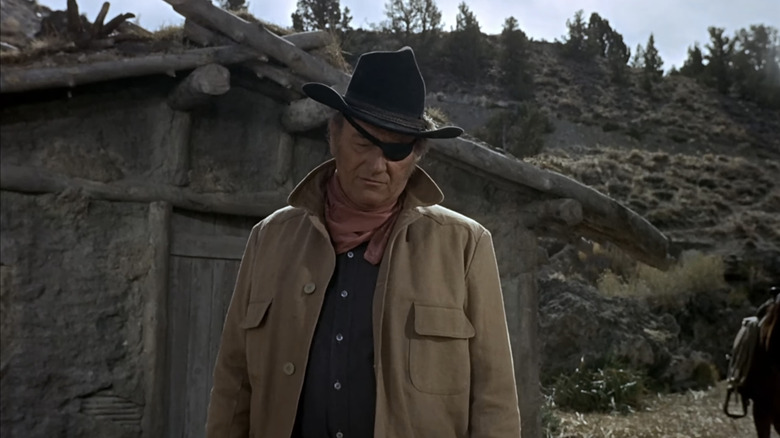 John Wayne's Reuben J "Rooster" Cogburn is seen from a low angle looking down in True Grit