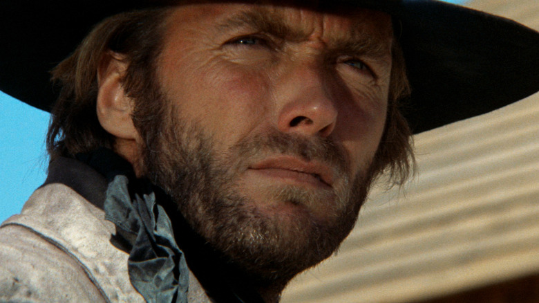 Clint Eastwood's The Stranger is seen in closeup as he stands outside a store in High Plains Drifter