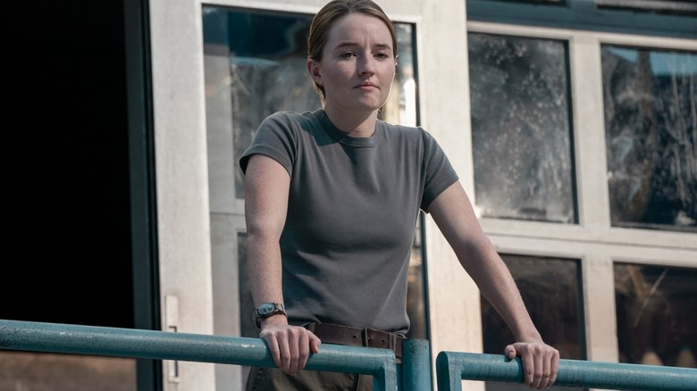 Abby stands and surveys the WLF compound in The Last of Us