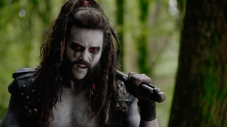 Emmett J. Scanlan as Lobo with his weapon over his shoulder on Krypton