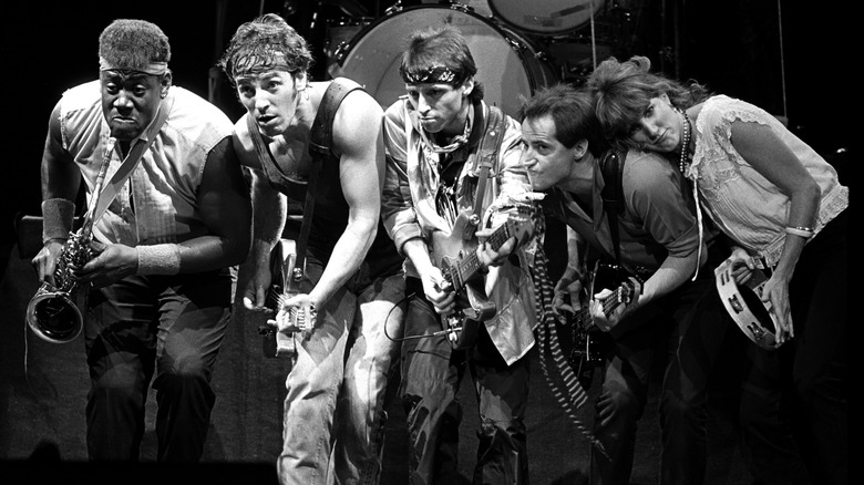 Black and white photo of the E Street Band on the Born in the USA Tour: Clarence Clemons, Bruce Springsteen, Nils Lofgren, Garry Tallent, and Patti Scialfa