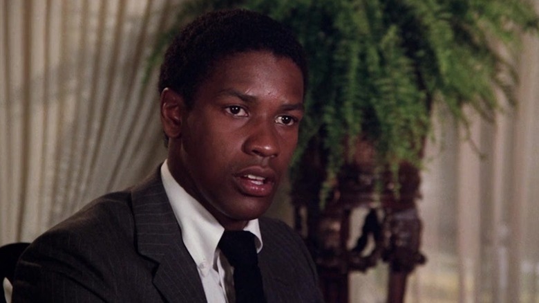 Denzel Washington looking uncomfortable at a dinner party as Roger Porter in Carbon Copy