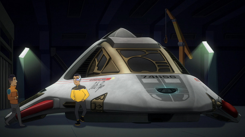The Delta Flyer as it was seen on Star Trek: Lower Decks. Ensign Rutherford stands next to it