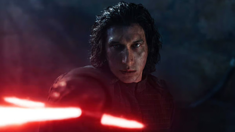 Kylo Ren takes aim with his lightsaber in Star Wars: The Force Awakens
