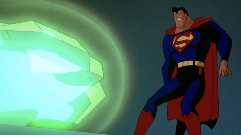 Superman backed against the wall, recoiling from Kryptonite