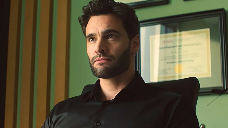 Dr. Bateman sitting in an office in The Love Hypothesis