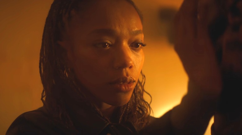 Naomi Ackie as Caitlyn Corr caressing the face of Tom Rhys Harries as Matt Hagen in Clayface