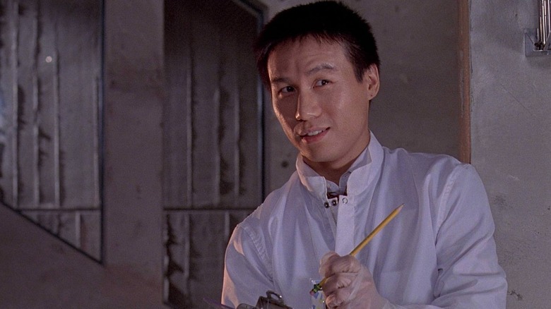 BD Wong as Dr. Henry Wu holding his clipboard and pencil in the lab in Jurassic Park