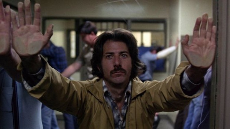Dustin Hoffman throws his hands in the air as Max Dembo in Straight Time