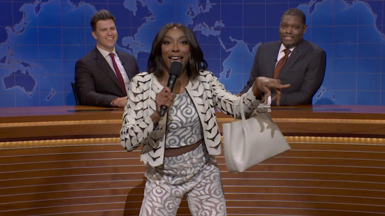 Ego Nwodim doing a stand-up bit in front of the Weekend Update desk on Saturday Night Live